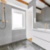 Luxurious gray bathroom with shower and large sink